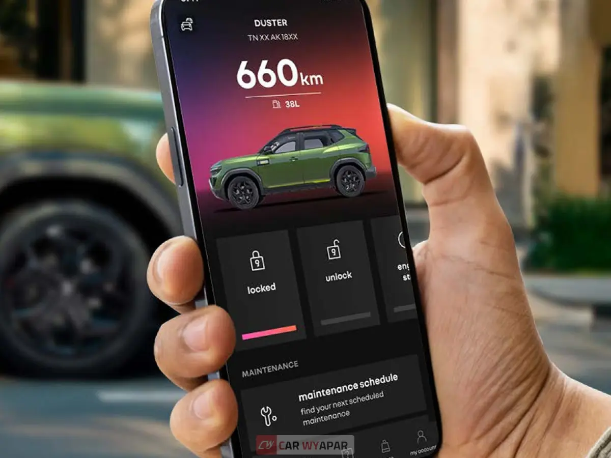 A hand holding a smartphone displaying the My Renault app used for remote vehicle tracking and status updates.